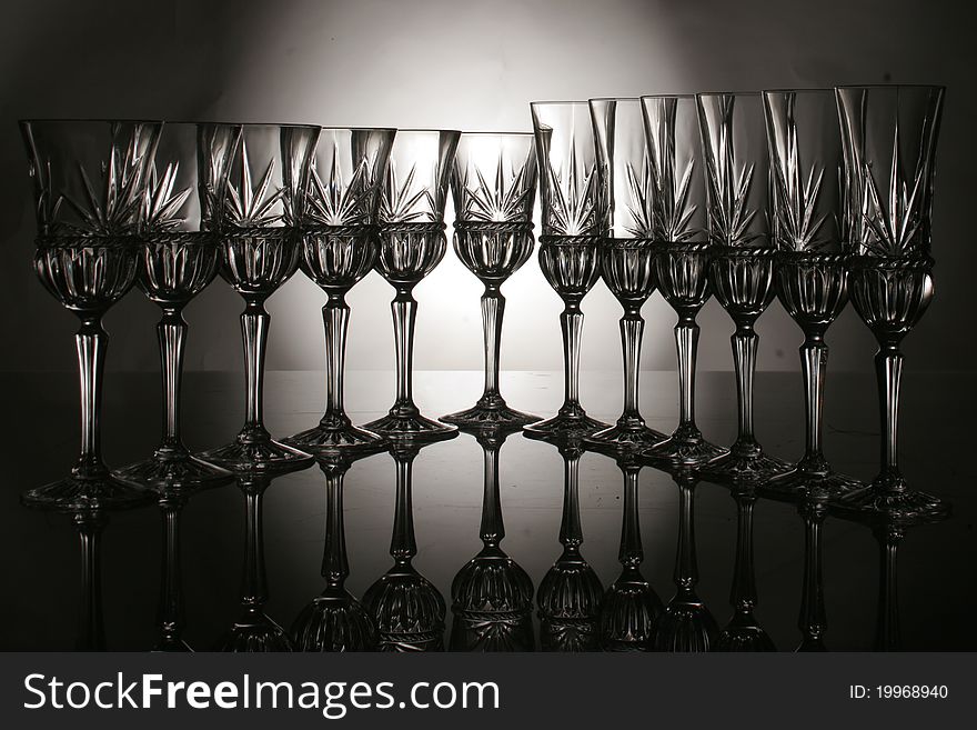 Crystal wine glass composition on the black background. Crystal wine glass composition on the black background