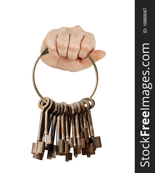 Fist with bunch of old keys on a big keyring. isolated on white. Fist with bunch of old keys on a big keyring. isolated on white