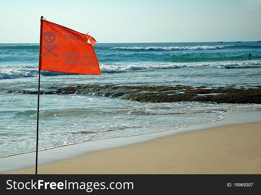 A flag warning that no swimming in this area of the beach