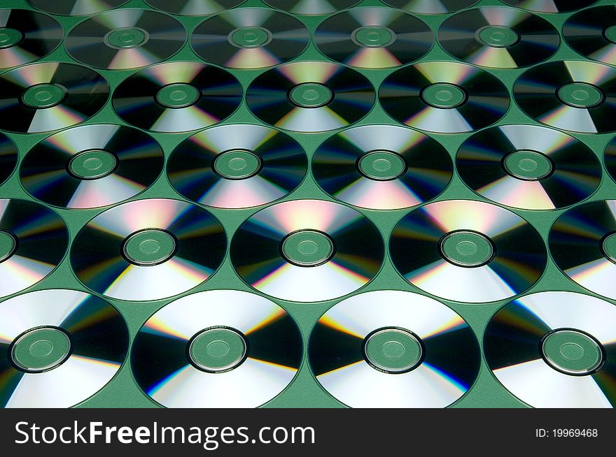 Pattern of CDs on green background. Pattern of CDs on green background
