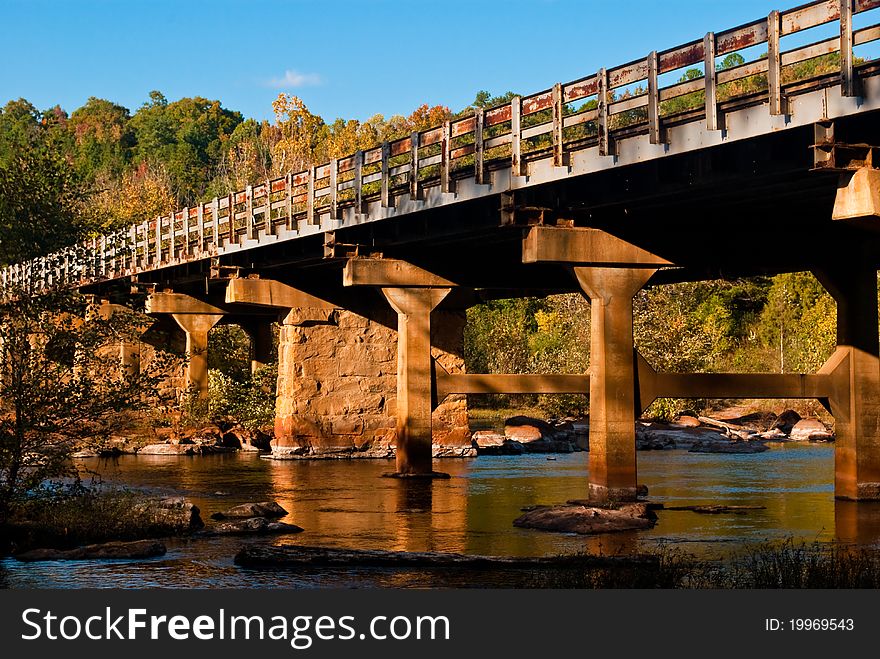 Bridge over a stream in Autumn. Bridge over a stream in Autumn.