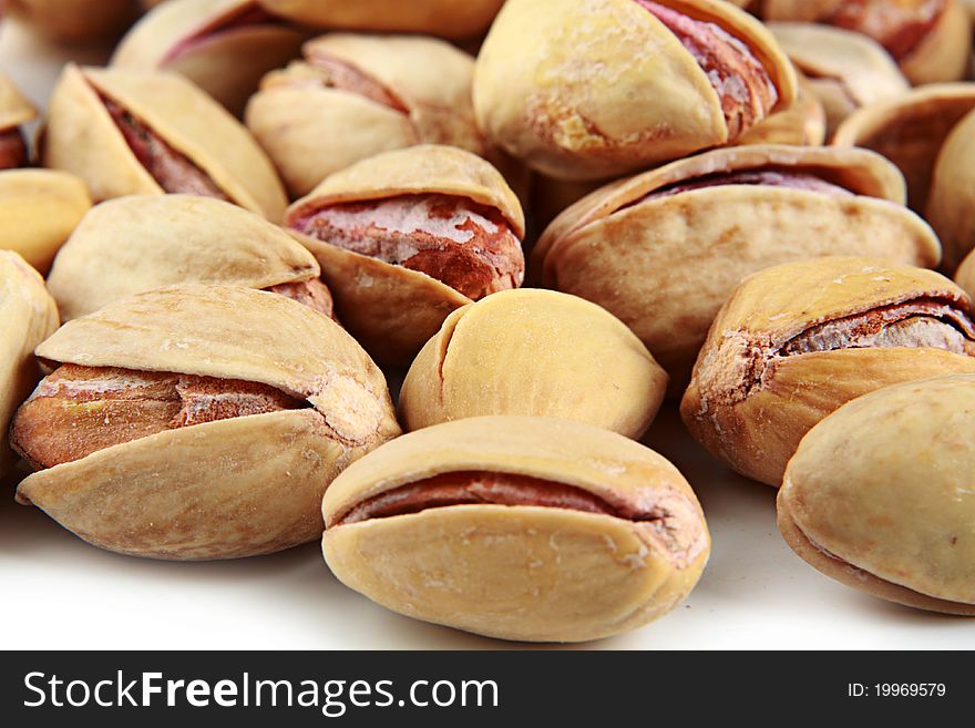 Pistachios, on a white background in studio. Pistachios, on a white background in studio.