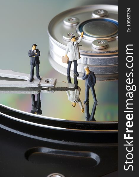 Three business man figures on hard disk. Three business man figures on hard disk