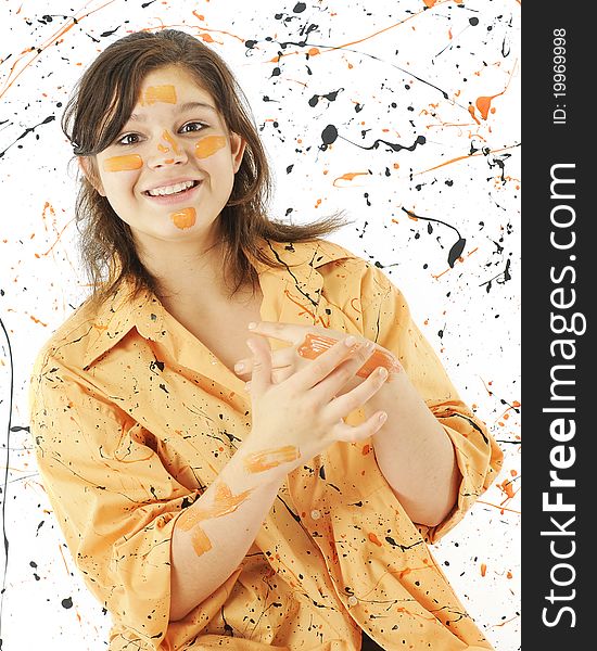 An attractive young teen, her orange smock and the while background spattered in Halloween-colored paint. An attractive young teen, her orange smock and the while background spattered in Halloween-colored paint.