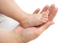 Baby Feet In Mommy S Hands Royalty Free Stock Photos