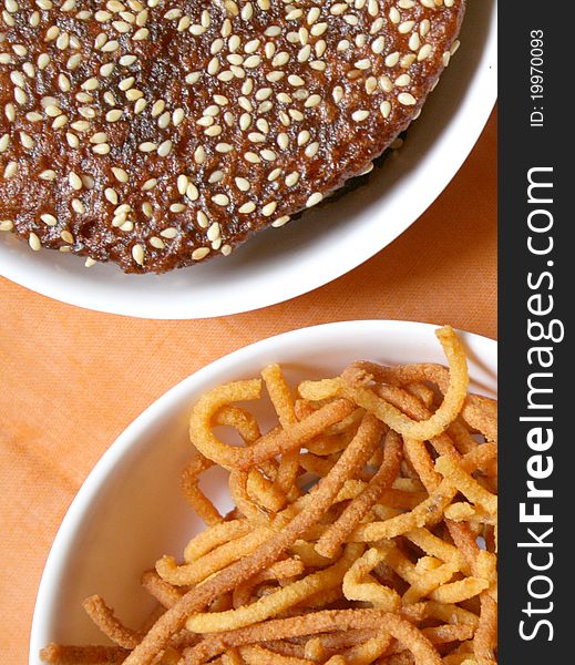 Variety of indian snacks on white background.