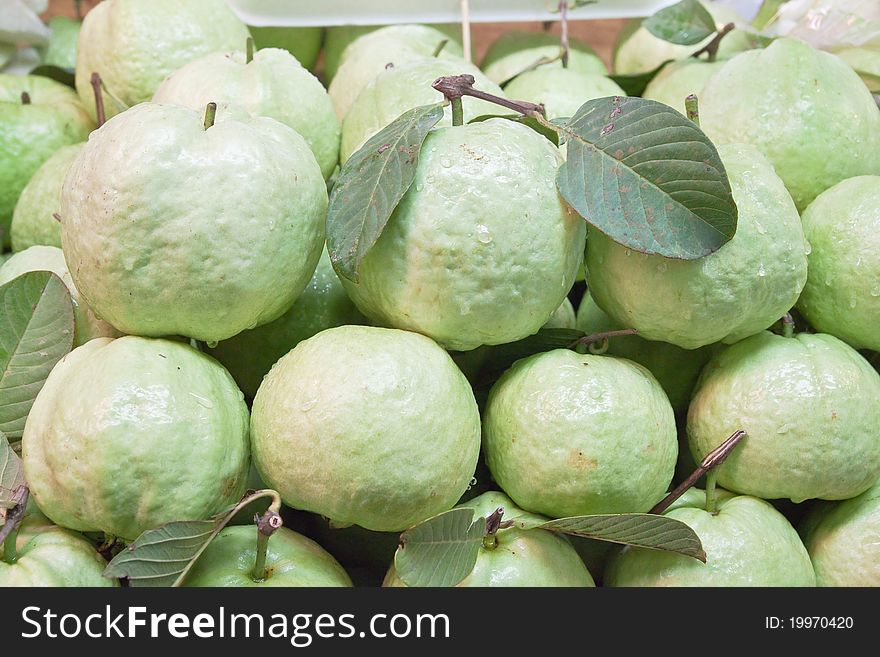 Fresh guavas with green leaf in fruit market.