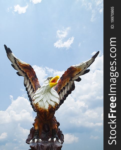 Sculpture of eagle on blue sky background. Sculpture of eagle on blue sky background