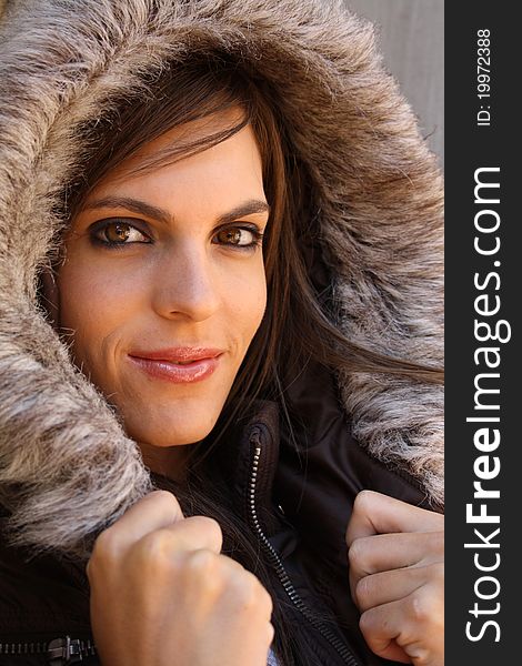 Attractive woman with fur hood and leather jacket