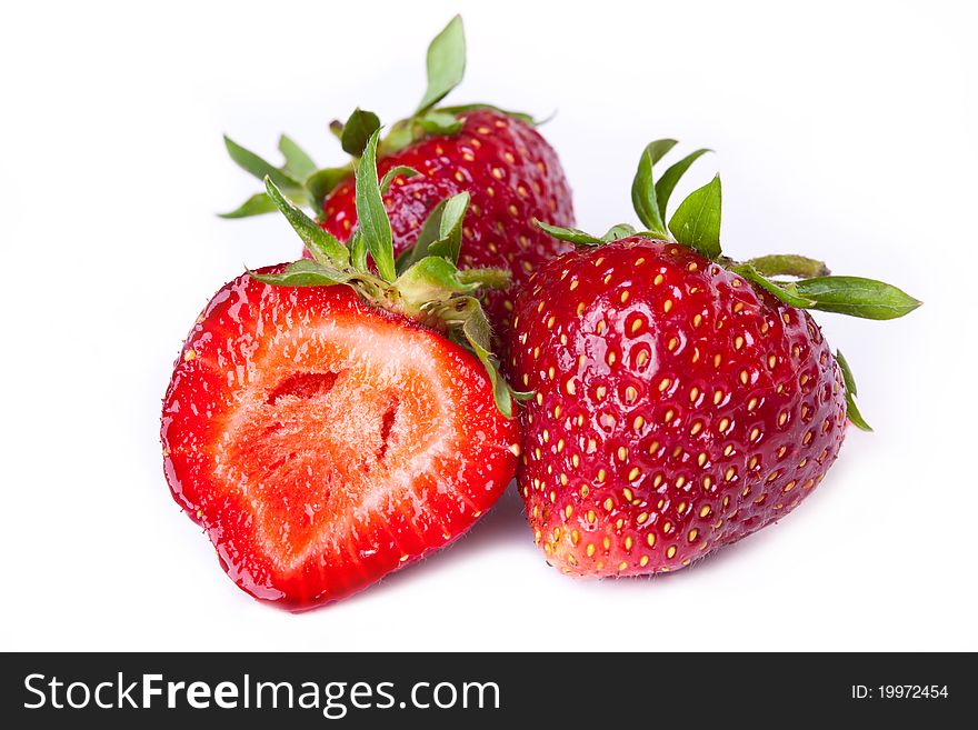 Macro of fresh strawberries across white