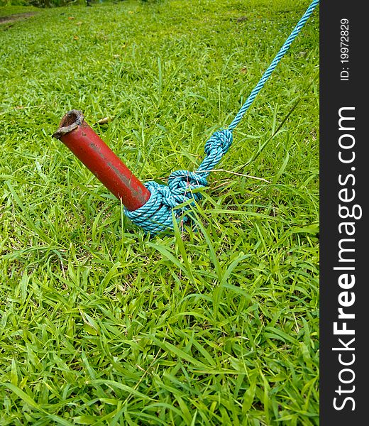 Red iron post and blue knot.