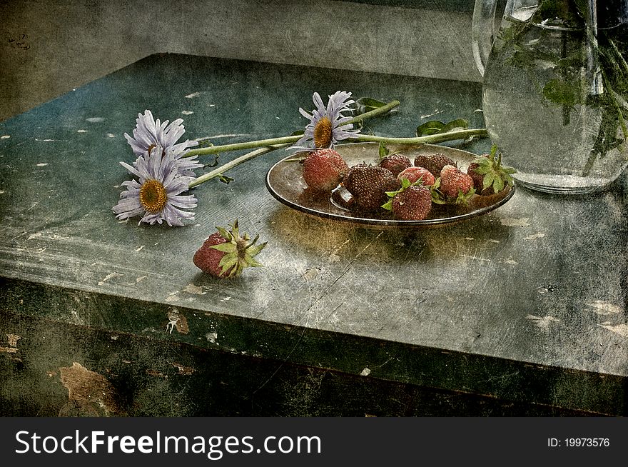 Still life with camomiles and strawberry