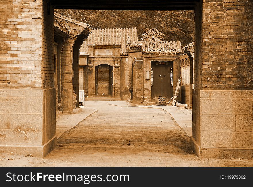Traditional Chinese alley in Beijing.It has more than 100 years of history. Chinese characters on both sides of door are Chinese couplet.