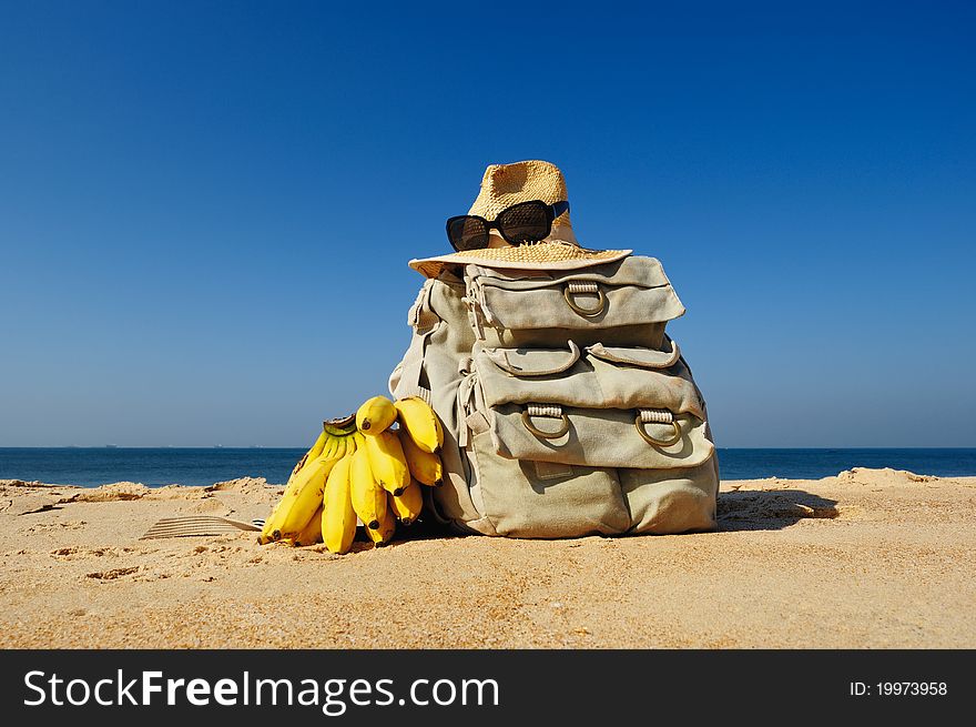 Rucksack, hat and bananas on the sandy beach. Rucksack, hat and bananas on the sandy beach