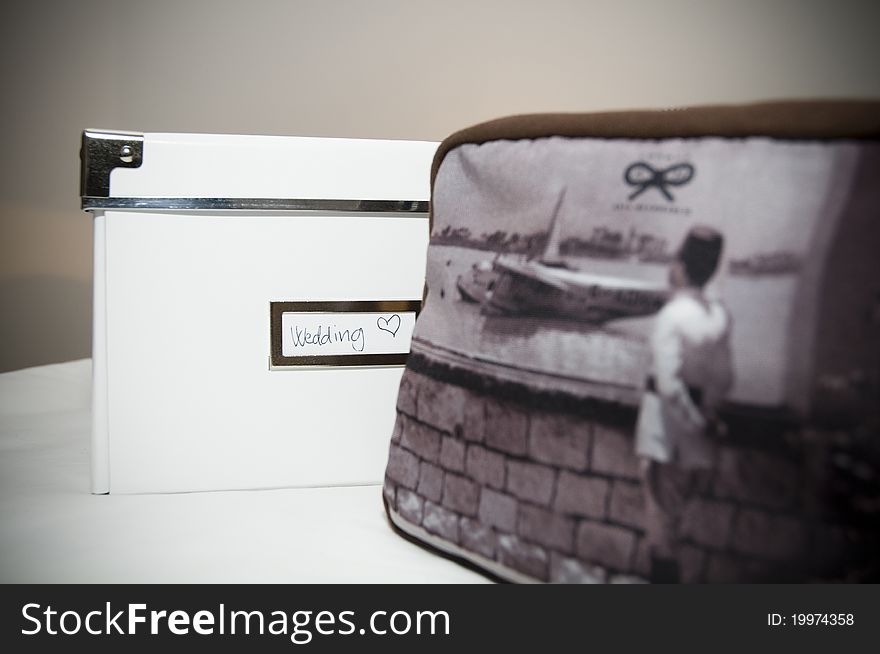 This is a wedding theme box with a writing on it next to a handbag. Simple and great. This is a wedding theme box with a writing on it next to a handbag. Simple and great.