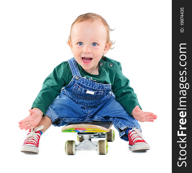 Cute 1 years old boy on a skateboard in the studio. Cute 1 years old boy on a skateboard in the studio