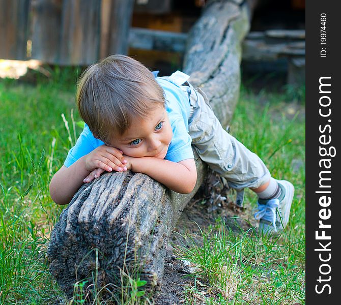 Cute 2 years old boy sitting on the the bench in the park. Cute 2 years old boy sitting on the the bench in the park