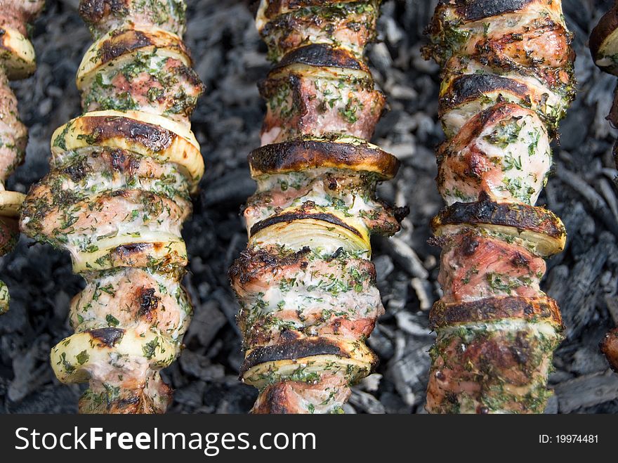 Tasty shish kebab shashlik meat on skewer on coal