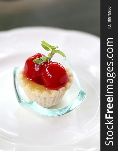 Mini cherry fruit tarts on dish Close-up