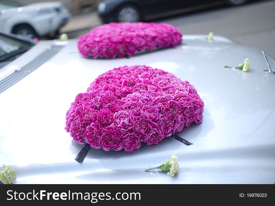 Flowers on a red wedding car. Flowers on a red wedding car