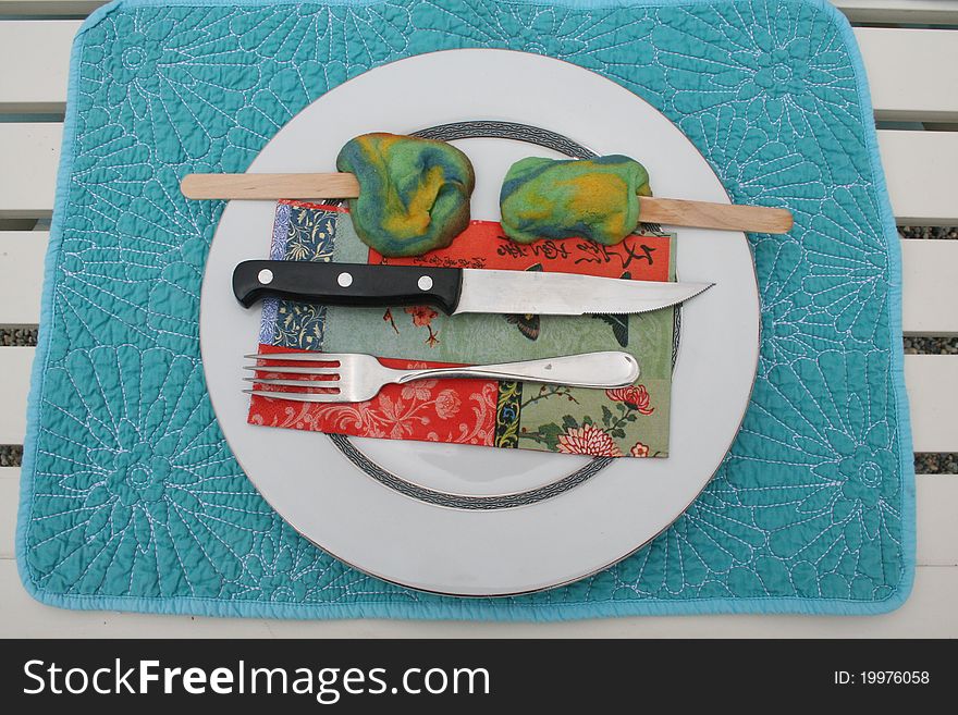 Blue place mat with plate, knife, fork, napkin and cookies. Blue place mat with plate, knife, fork, napkin and cookies.