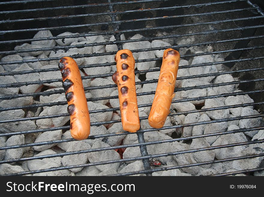 Vegie dogs cooking on the grill.