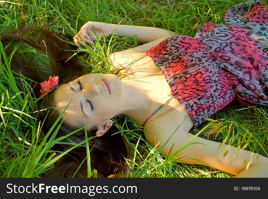 The young girl lies in a grass blindly