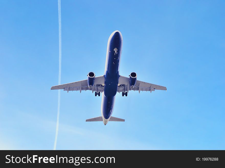 Airbus in blue sky and trace of another airplane.