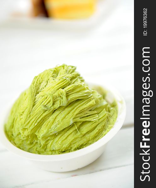 Green ice cream on white background