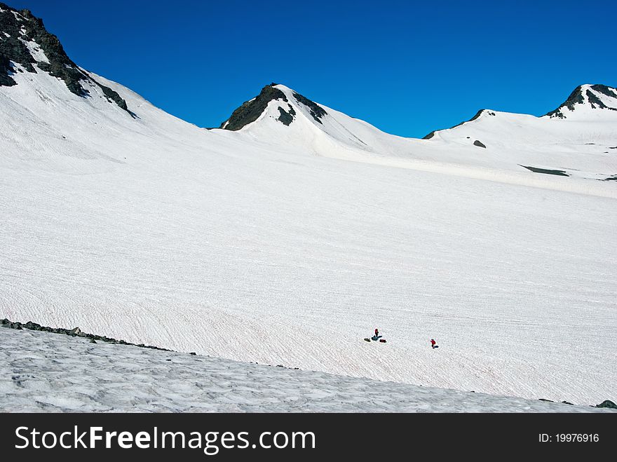 Huge white glacier with people on it