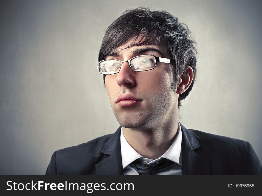 Young businessman wearing stained glasses. Young businessman wearing stained glasses