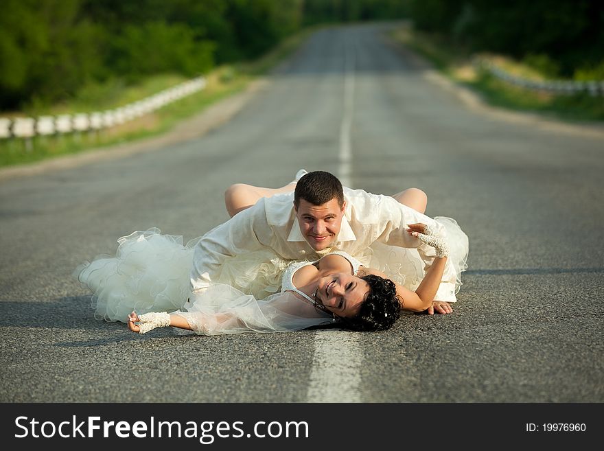 passion between bride and groom on countryside road