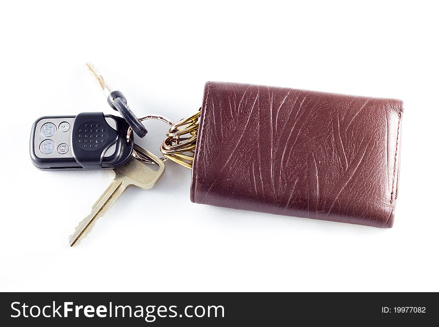 Car alarm key, car key and its wallet (on white background). Car alarm key, car key and its wallet (on white background).