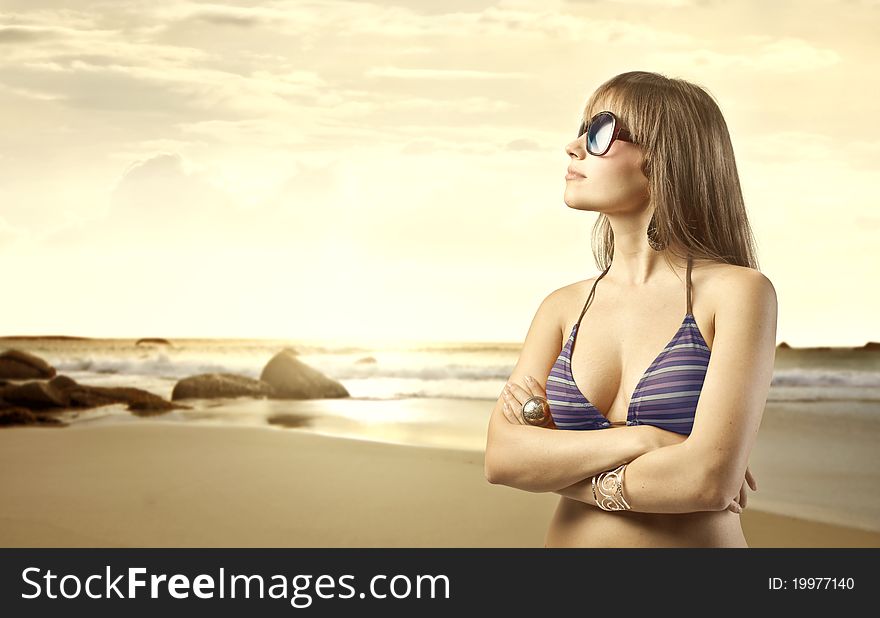 Beautiful woman in swimsuit with seaside in the background. Beautiful woman in swimsuit with seaside in the background