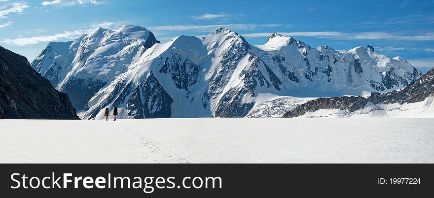 Couple crossing huge glacier at Altai mountains. Couple crossing huge glacier at Altai mountains