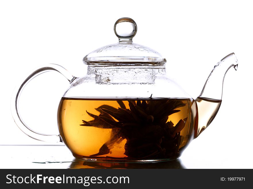 Tea in glass pot isolated