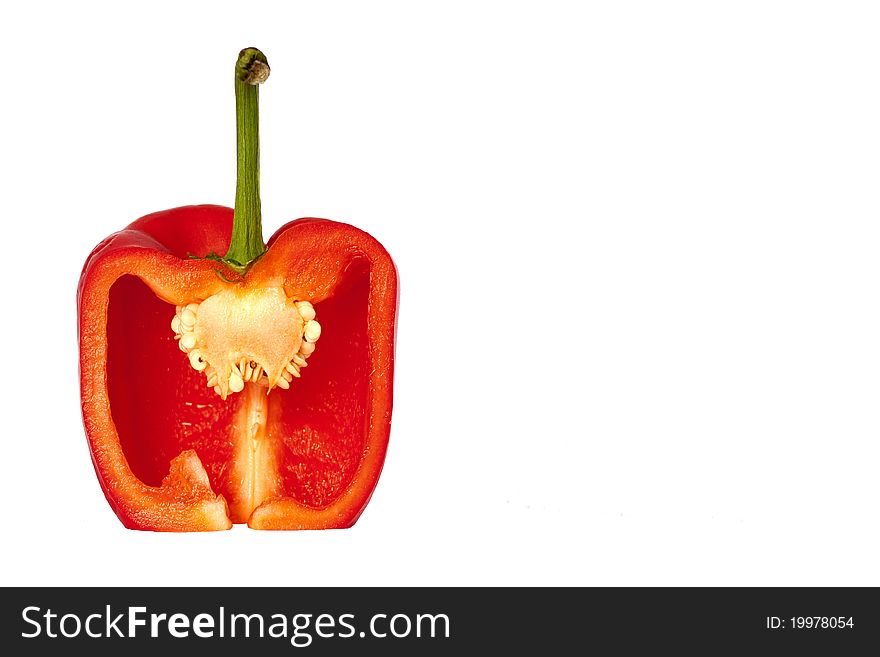 A red bell pepper from the side cut open and isolated. A red bell pepper from the side cut open and isolated