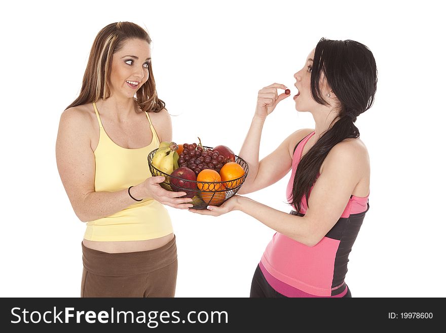 Two women being healthy eating fruit. Two women being healthy eating fruit.