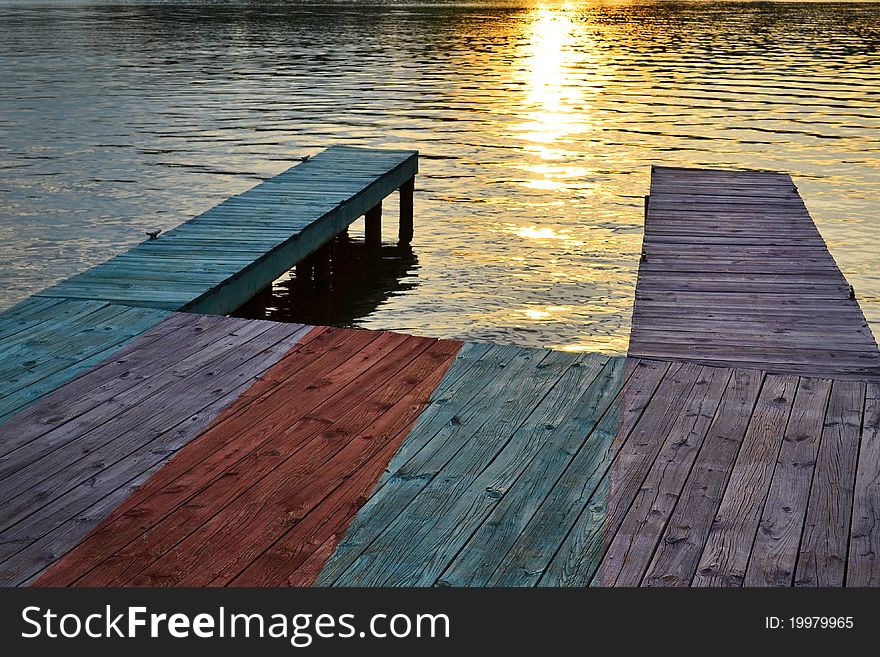 Old wooden boat dock on a lake at sunset. Old wooden boat dock on a lake at sunset