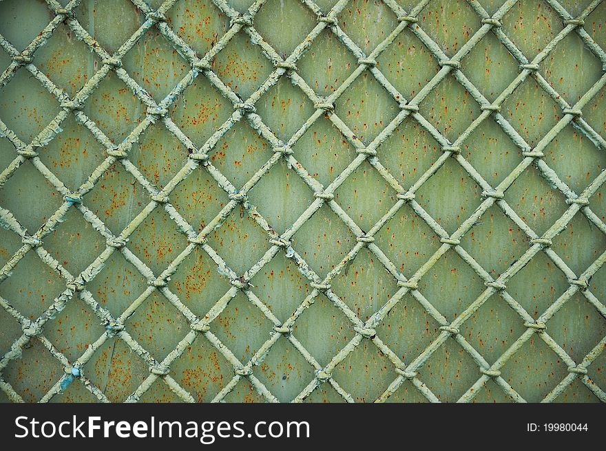 Old metal grill fence with peeling paint