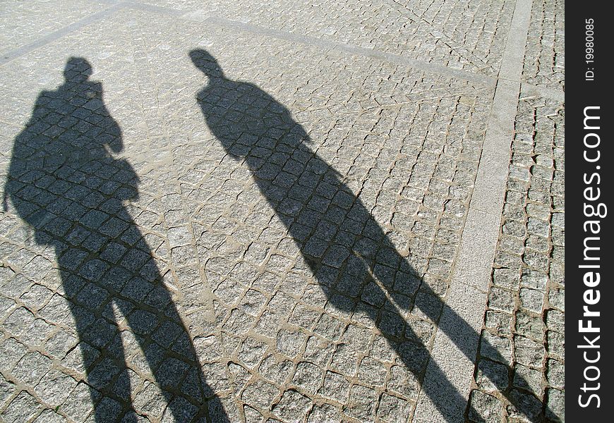 Shadows two men on the town square. Shadows two men on the town square