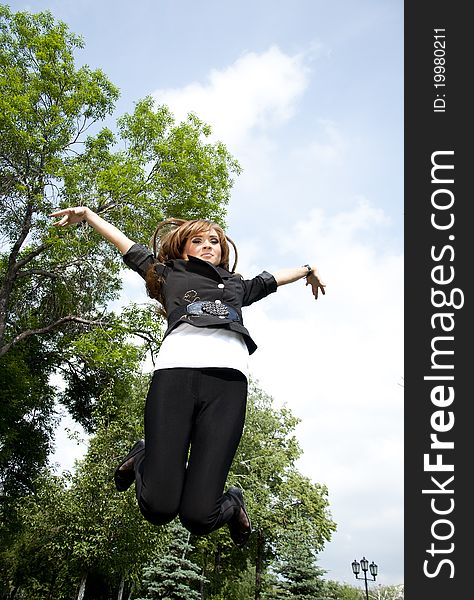 Young girl jumping in park