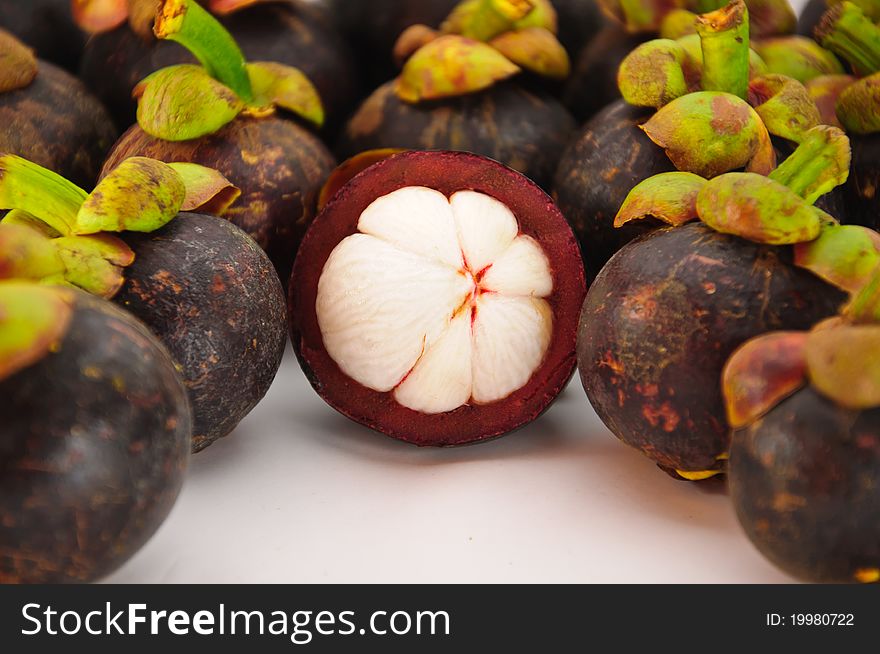 Mangosteens are tropical fruit to be isolated in hite background. Mangosteens are tropical fruit to be isolated in hite background.