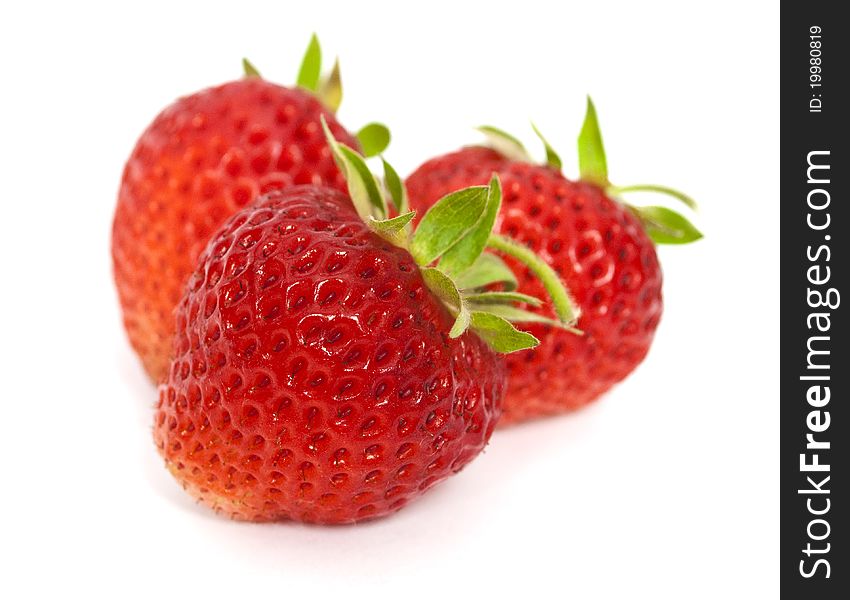 Three tasty strawberries isolated on the white background. Three tasty strawberries isolated on the white background