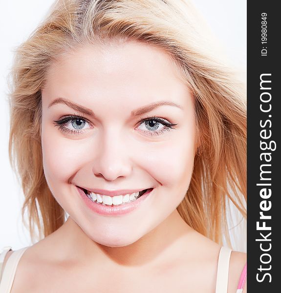 Attractive blonde smiling woman portrait on white background. Attractive blonde smiling woman portrait on white background