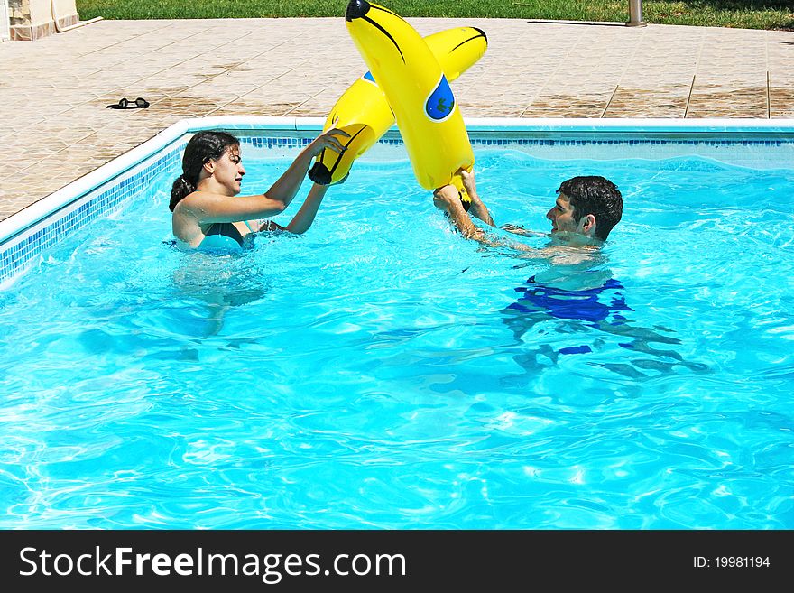 Couple having fun in swimming pool. Couple having fun in swimming pool.