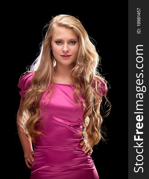 Young woman with beautiful blonde hair on a black background