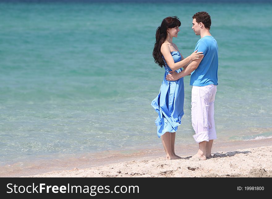 Young loving couple on sea background. Young loving couple on sea background
