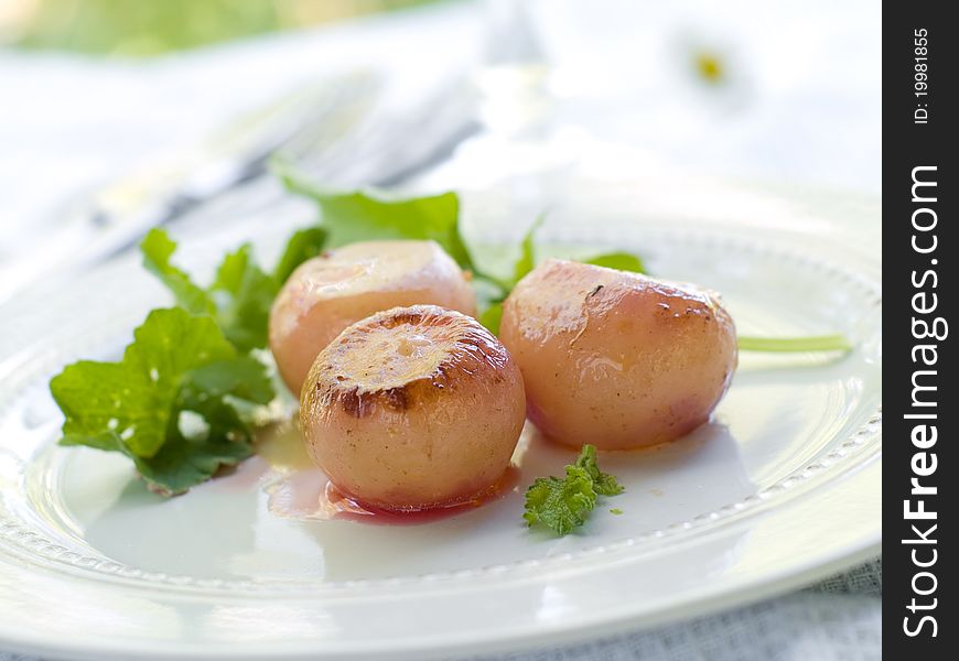 Roasted potatoes with arugula. Selective focus