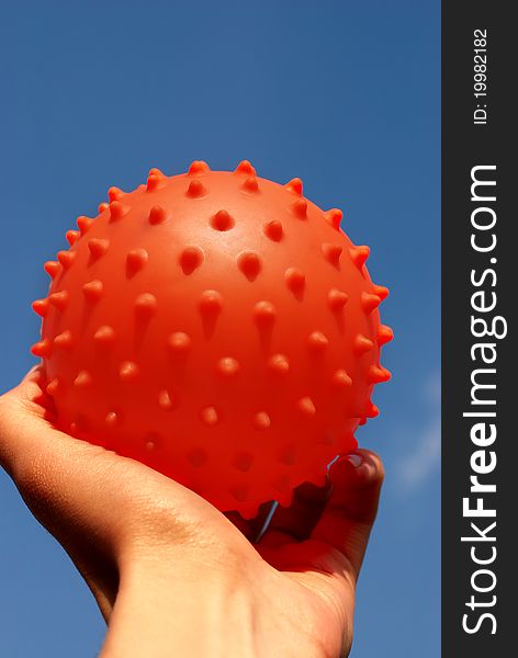 Ball in hand against the blue sky